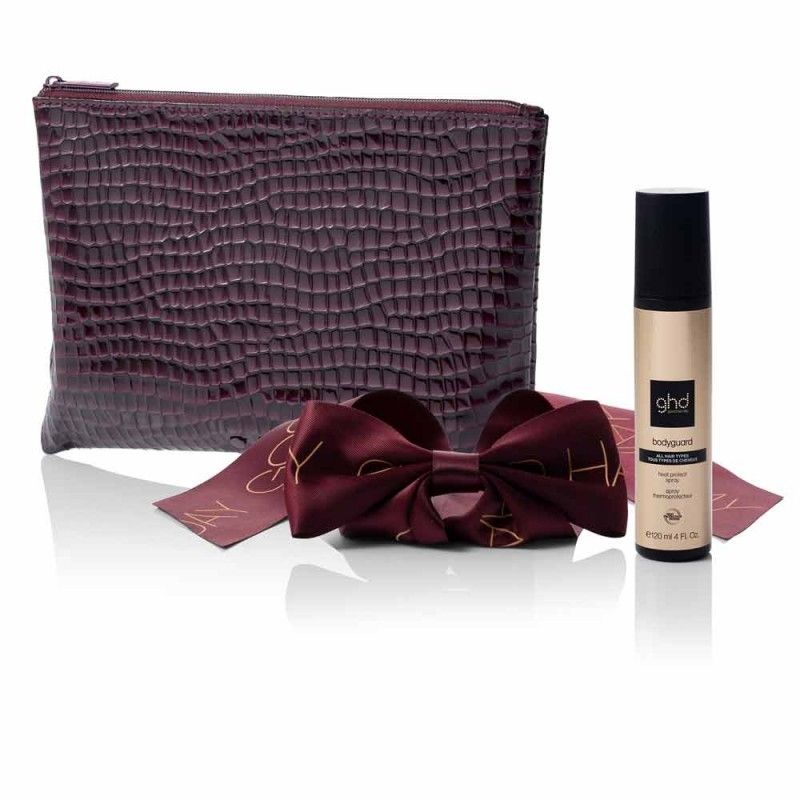Maroon textured pouch with two red bows and a ghd hair product on a white background
