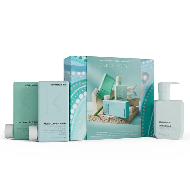 Kevin Murphy hair care products including a box, bottles, and packets on a white background