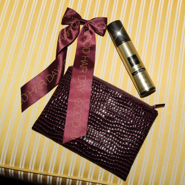 Good Hair Day hair product with a decorative bag and ribbon on a striped background